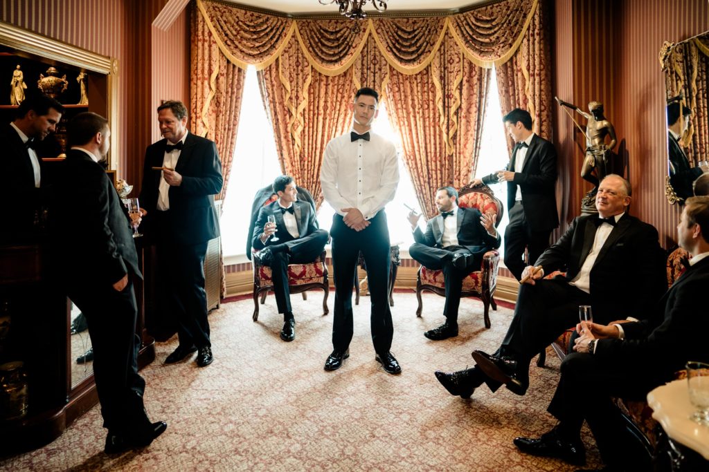 The groomsmen hang out in their suite at The Haley Mansion