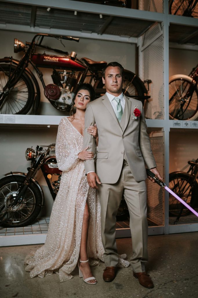 Wedding couple poses in front of the motorcycle gallery at Warehouse 109