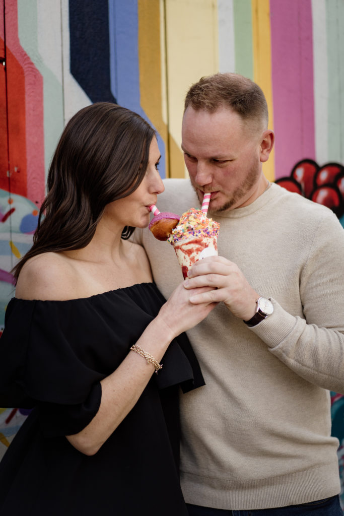 couple drinking milkshake for engagement photos
