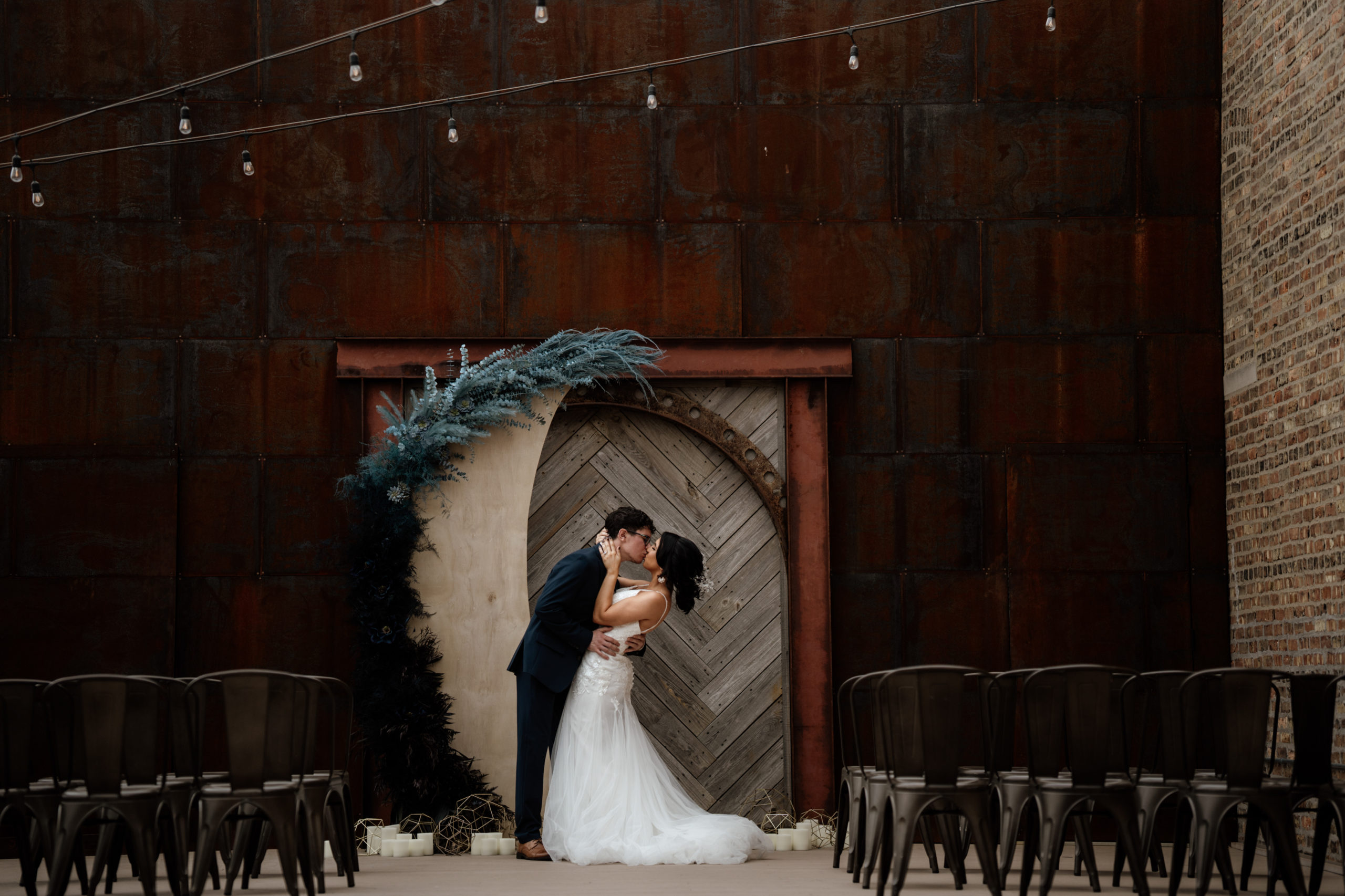 couple kissing at wedding venue